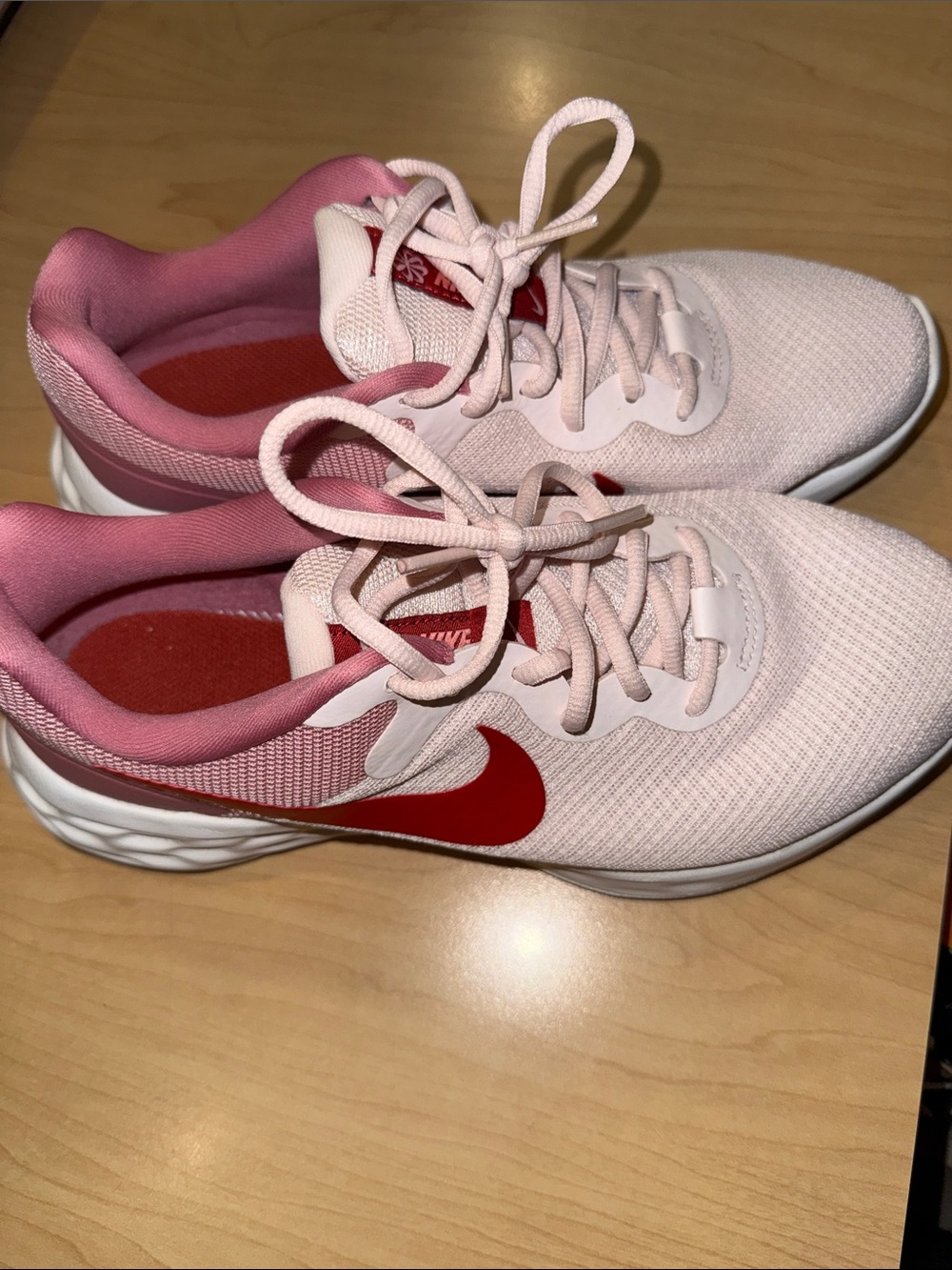 Nike Women’s Light Pink Running Shoes with Red Swoosh
